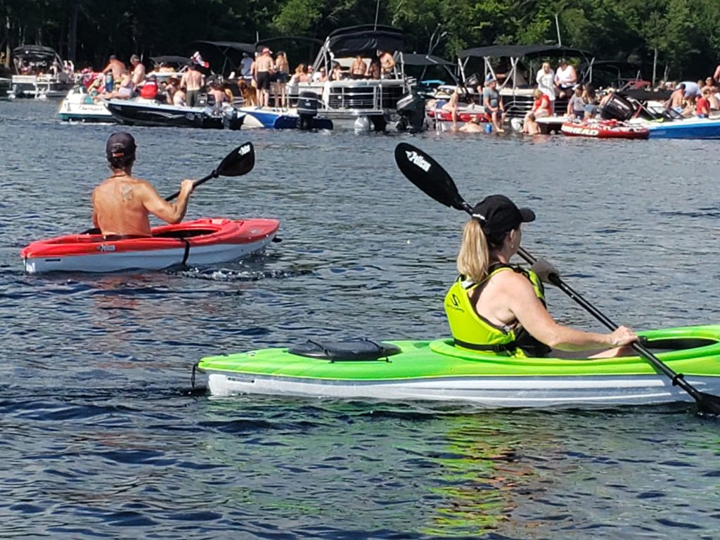 Kayakers and boats gathered on Redstone Lake